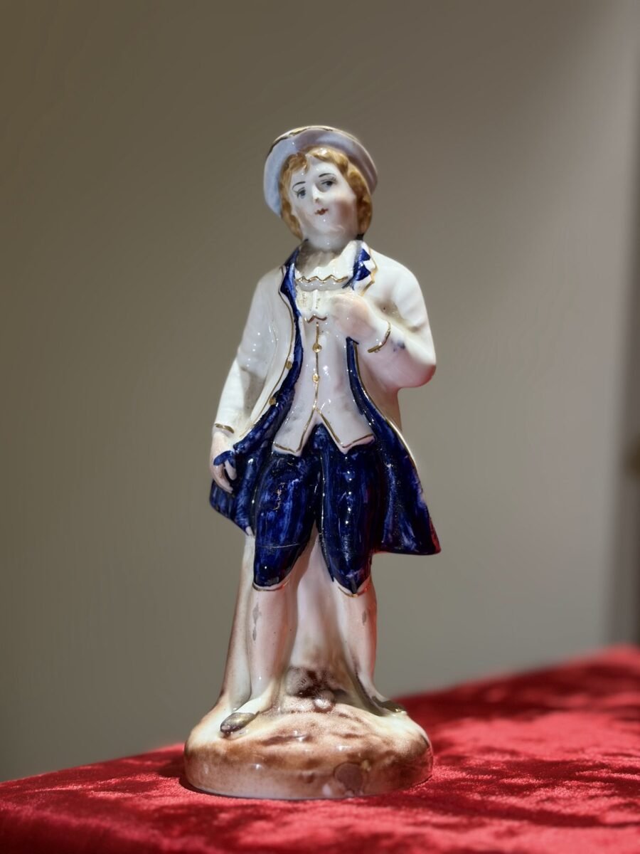 Porcelain figurine of a gentleman in a blue coat