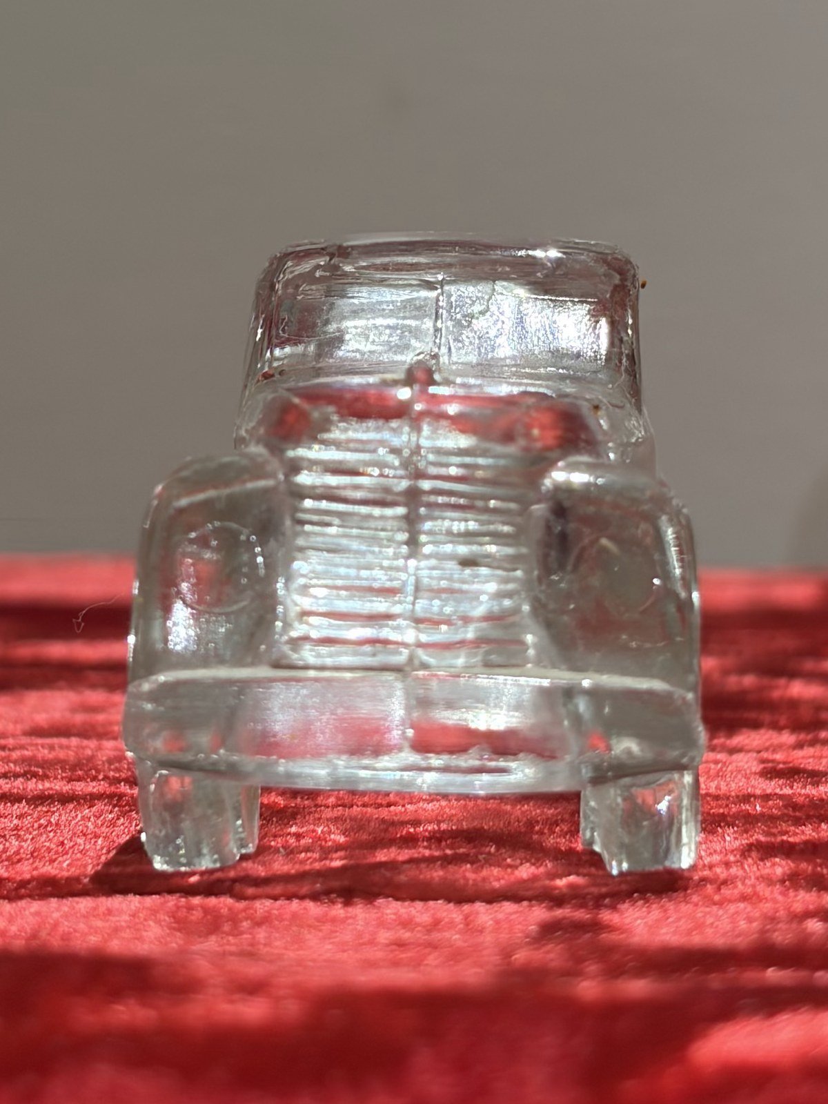 Pressed-glass model car, front view showing the grille
